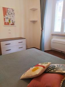 羅馬的住宿－Dimora Ninfee，一间卧室配有一张带枕头和梳妆台的床