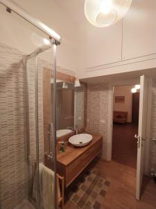 a bathroom with a sink and a shower at Dimora Ninfee in Rome