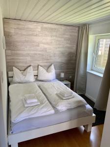 a bedroom with a white bed with two towels on it at Ferienwohnung Winterberg Lodge in Winterberg