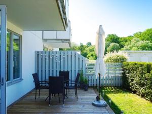 a patio with a table and chairs and an umbrella at 4 person holiday home in Visby in Visby