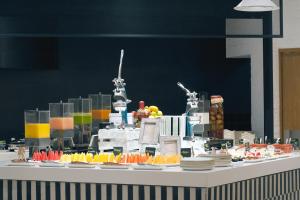 a buffet with plates of food on a table at Presidente InterContinental Guadalajara by IHG in Guadalajara