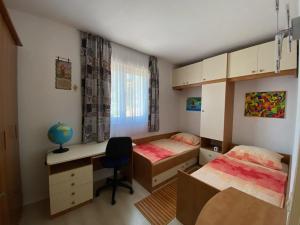 a dorm room with two beds and a desk and a desk at Apartment Sandra FREE PRIVATE PARKING in Dubrovnik