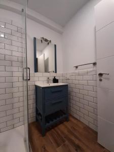 a bathroom with a sink and a mirror at Apartamentos El Muelle Comillas in Comillas