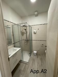 a bathroom with a shower and a sink at Casavienna app A2 in Varazze