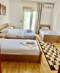 Postel nebo postele na pokoji v ubytování Beqa Apartments + 6 fotografií