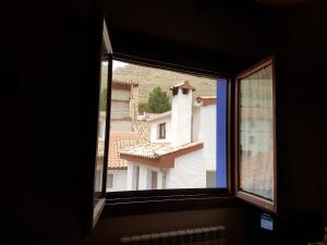 a window with a view of a building at Hotel Rural El Horno de Aliaga in Aliaga