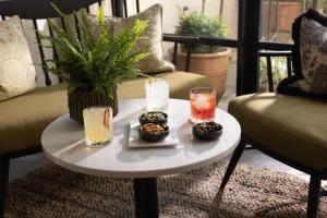 a table with two drinks and bowls of food on it at The Yard in Bath Hotel in Bath