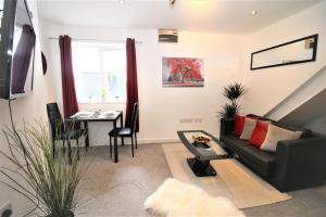 una sala de estar con un sofá y una mesa en Northcote Lane Apartments - By Property Promise, en Cardiff