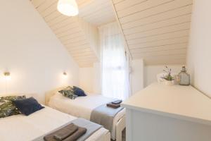 A bed or beds in a room at Holiday House Siófok