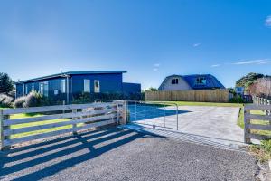 a gate to a house with a fence at SeaRenity - Waimarama Holiday Home in Waimarama