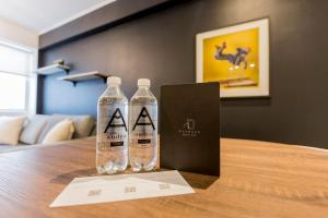 two bottles of water sitting on top of a table at Artistic 2BR in Luxury Building in Lima