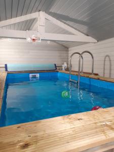 a swimming pool with a water fountain in a house at Gîte Le Bon Normand in Ã‰tainhus