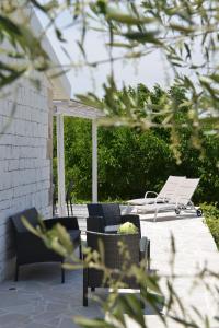 a patio with lounge chairs and avisorangering at Dimore Barsento in Alberobello