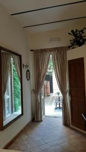 a room with a door and a window with curtains at B&B del Giglio in Cefalù
