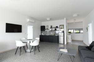 a living room with a couch and a table and chairs at Buric House - M suite - 95m2 and 54 m2 terrace in Rovinj
