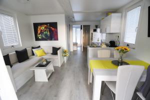 a living room with a couch and a table at Floating Sea House SONČEK in Portorož
