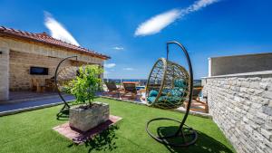 a yard with two swings on a house at Villa Pajkan in Dubrovnik