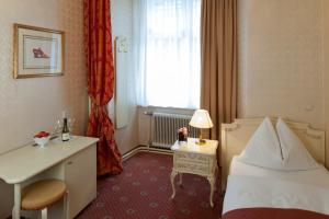 Rúm í herbergi á Pertschy Palais Hotel