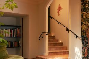 a staircase in a home with a book shelf at Hotel la Ponche in Saint-Tropez