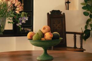 a bowl of fruit sitting on a table at Hotel la Ponche in Saint-Tropez