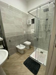 a bathroom with a shower and a toilet and a sink at Nammuratè - Casa Vacanze in Naples +17 photos