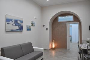 a living room with a couch and a table at Nammuratè - Casa Vacanze in Naples