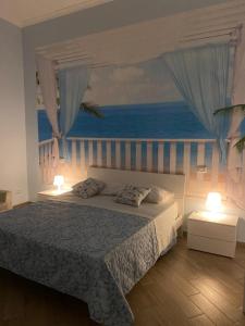 a bedroom with a bed with a view of the ocean at Nammuratè - Casa Vacanze in Naples