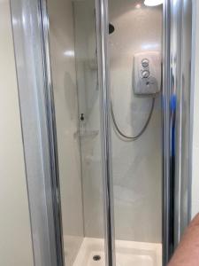 a shower with a glass door in a bathroom at No 29 Bed and Breakfast in Inverness