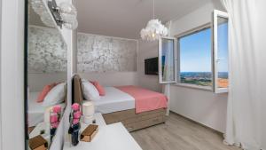 a small bedroom with a bed and a window at Villa Pajkan in Dubrovnik +85 photos