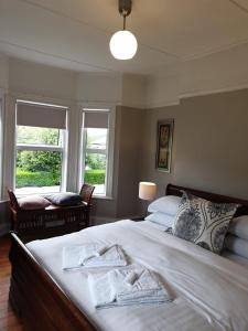 a bedroom with a large bed with towels on it at Grey Heron Townhouse in Newcastle