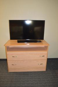 a flat screen tv sitting on top of a dresser at Budget Inn in Paso Robles