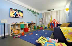 a childs play room with a blue wall at Best Western Grand Hotel Guinigi in Lucca