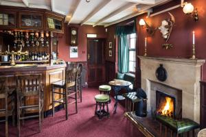 a bar with a fireplace in a pub at Duke Of Wellington Inn in Danby