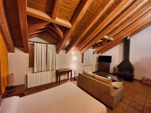 a living room with a couch and a fireplace at Tierras de Moya in Los Huertos