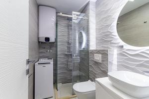a bathroom with a shower and a toilet and a sink at Miramare Apartments Pržno in Pržno