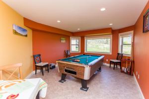 a pool table in a room with orange walls at Overlander B&B in Kamloops