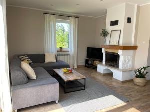 a living room with a couch and a table at Willa Julianna in Mikołajki