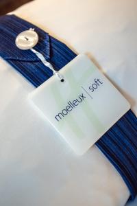 a white tag on top of a blue tie at Holiday Inn Express Dijon, an IHG Hotel in Dijon