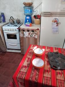 a kitchen with a table and a stove and a counter top at Apapachar in Amaichá del Valle