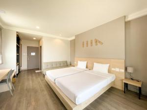 Postel nebo postele na pokoji v ubytování Rayong Chalet Resort