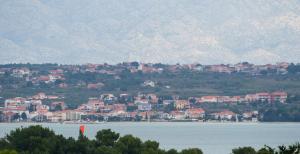 a town on the shore of a large body of water at Apartment Village Nin in Nin