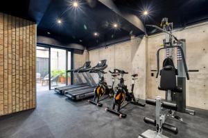 a gym with three treadmills and three bikes at UTOPIC Roma Norte by ULIV in Mexico City
