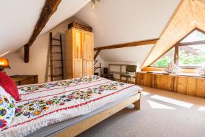 a bedroom with a bed and a window at Dom Pod Orzechem in Łapczyca