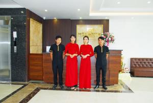 a group of people standing in a lobby at Melanta Hotel in Sầm Sơn