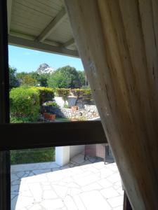 a view of a garden from a window at To Pithari in Skiros