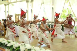 a group of dancers dancing in a room at Manor House-Kandy in Kandy