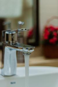a close up of a water faucet on a sink at Lakshmi Apartment Novy Arbat 3-bedroom in Moscow