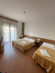 Postel nebo postele na pokoji v ubytování Hotel Leuco'