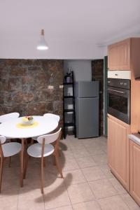 a kitchen with a white table and chairs in a room at Apartman Nico, Volosko, PET FRIENDLY in Opatija +14 photos