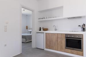 a white kitchen with a sink and a dishwasher at Archon Seaside Retreat in Plaka